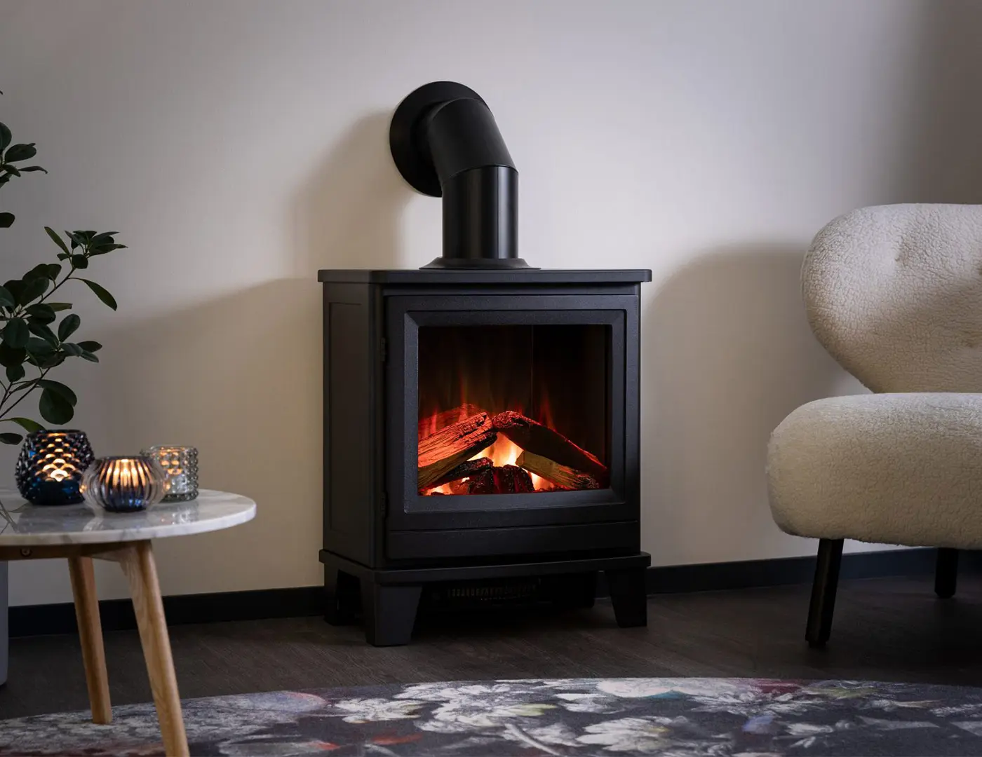Black freestanding electric fireplace in cast iron with a false flue attached